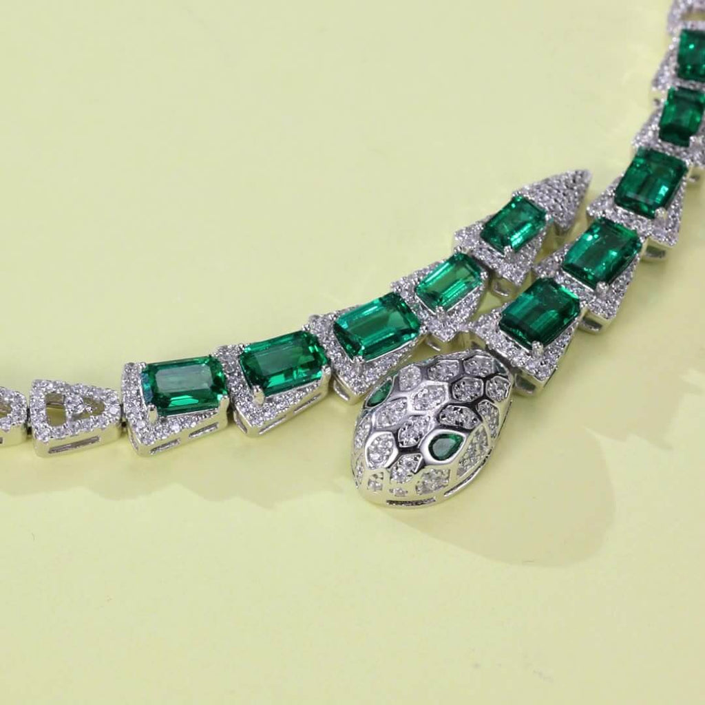 Elegant snake-head emerald bracelet in sterling silver