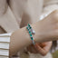 Model with a stylish snake bracelet with lab-created emeralds in her wrist